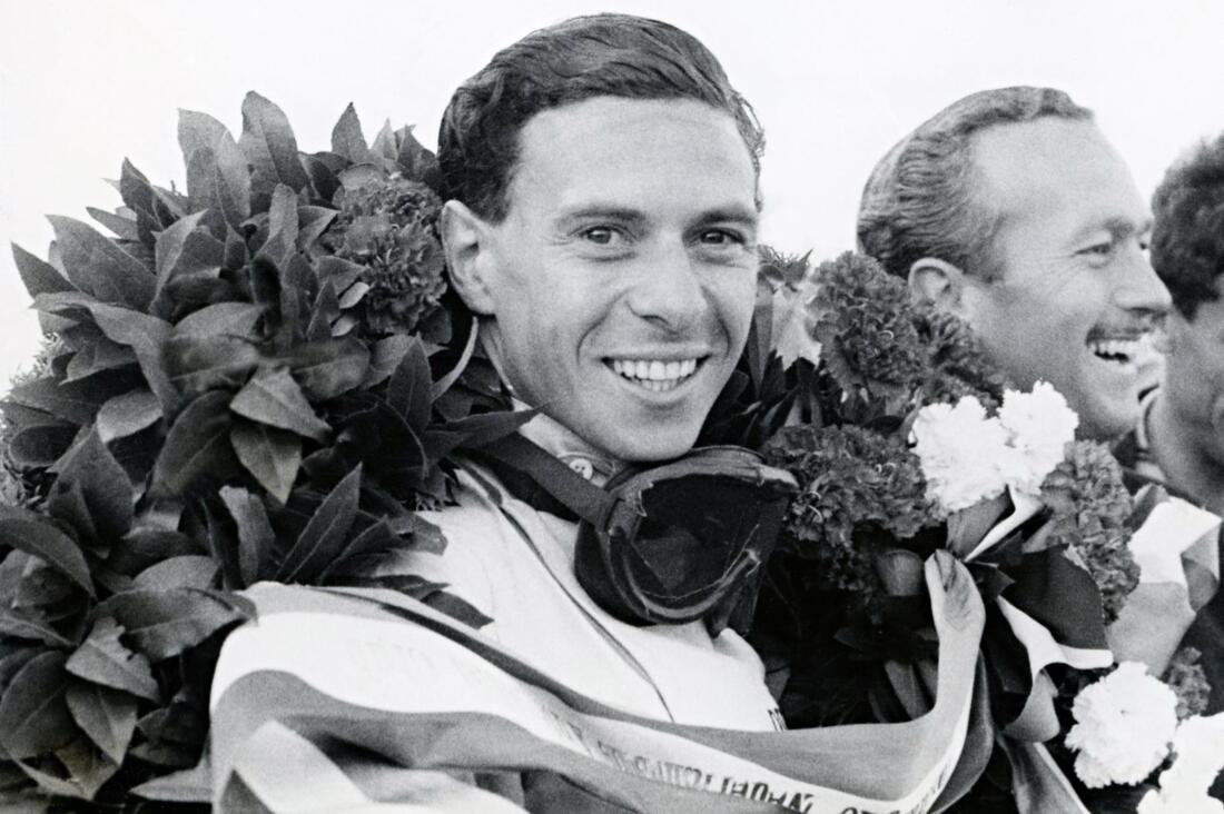 Jim Clark celebrates his triumph with Lotus Type 38
